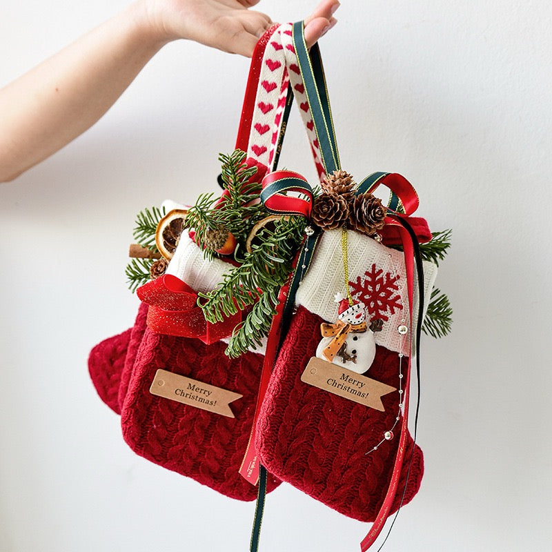 Knitted Christmas stockings held by their ribbons