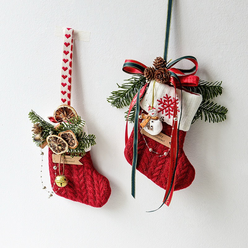 Two knitted Christmas stockings hanging on a wall