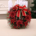 Red Christmas wreath with glitter poinsettia flowers and ribbon bow